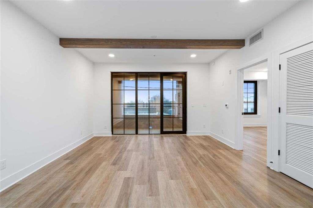 346 Peters Street Southwest, Unit 308 Atlanta, GA 30313 - Photo 2 of 19 wooden floor in an empty room with a window