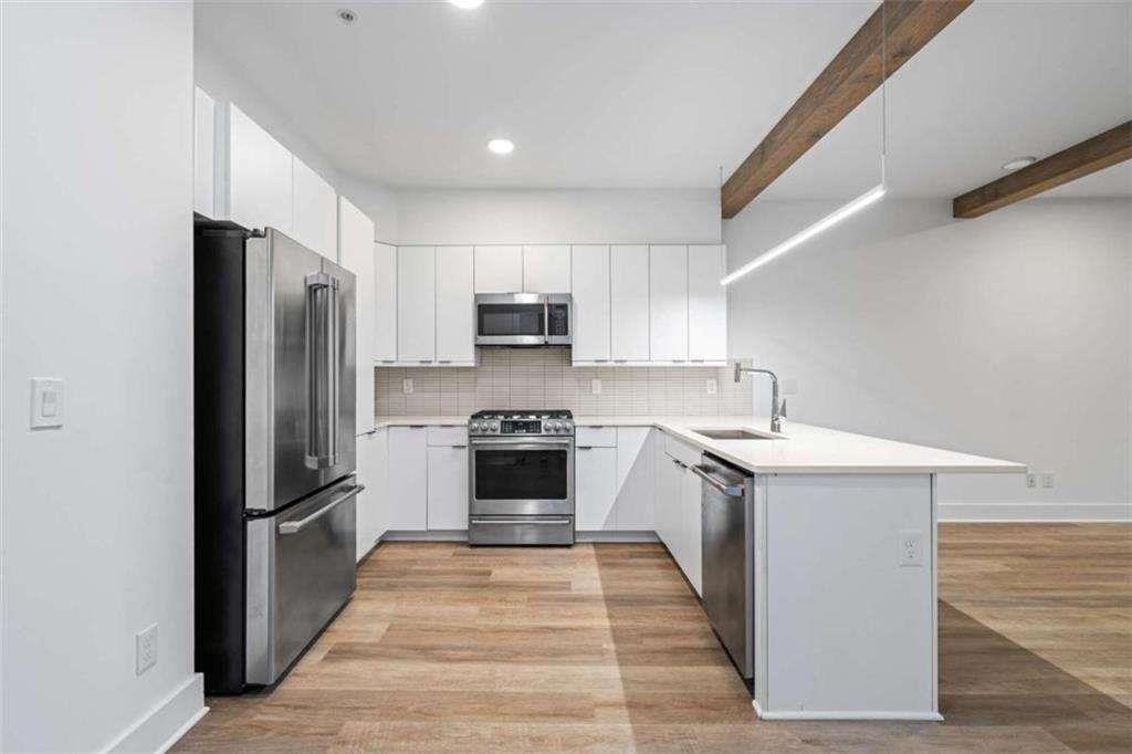 346 Peters Street Southwest, Unit 308 Atlanta, GA 30313 - Photo 3 of 19 a kitchen with a refrigerator stove and sink