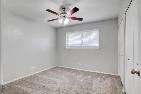 8230 El Retiro Road Fort Worth, TX 76116 - Photo 15 of 21 an empty room with a chandelier fan and windows