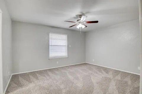 8230 El Retiro Road Fort Worth, TX 76116 - Photo 16 of 21 an empty room with a window and a fan