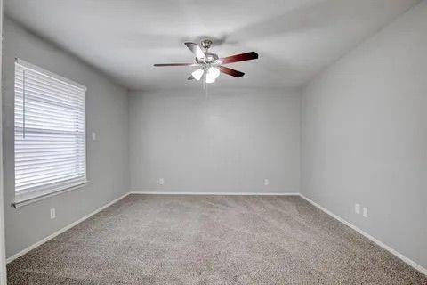 8230 El Retiro Road Fort Worth, TX 76116 - Photo 17 of 21 an empty room with a window and a fan