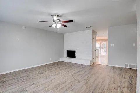 8230 El Retiro Road Fort Worth, TX 76116 - Photo 6 of 21 a view of an empty room with wooden floor and a ceiling fan