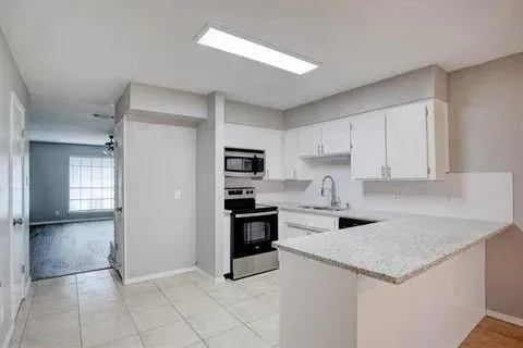 a kitchen with a stove a refrigerator and a sink