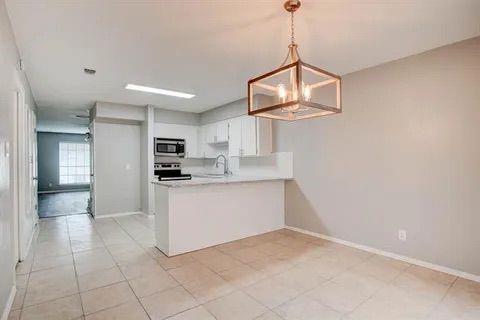 8230 El Retiro Road Fort Worth, TX 76116 - Photo 10 of 21 a kitchen with white cabinets and window