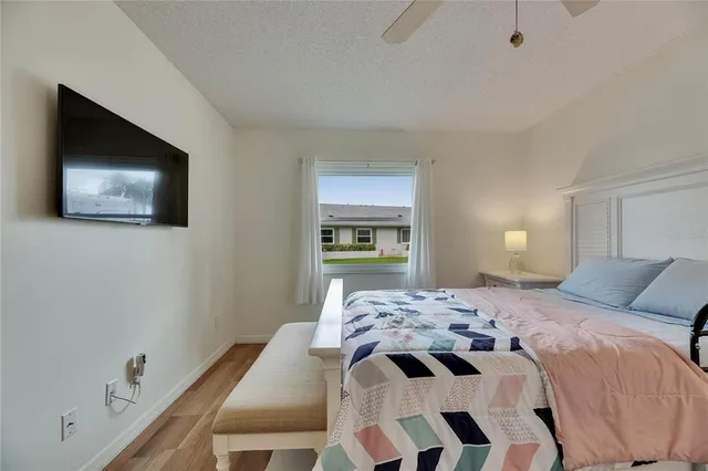 a bedroom with a bed and a tv