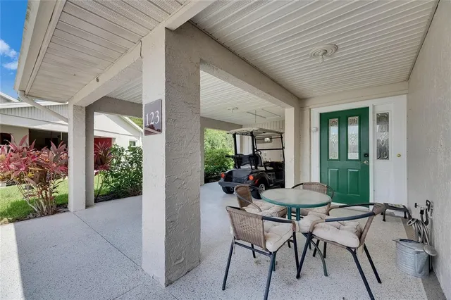 a view of a patio with table and chairs and potted plants