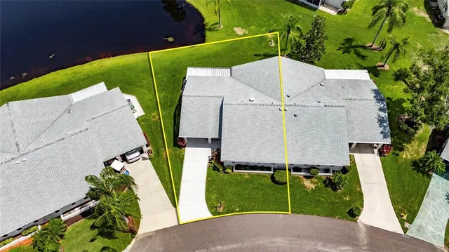 an aerial view of a house with garden space and street view