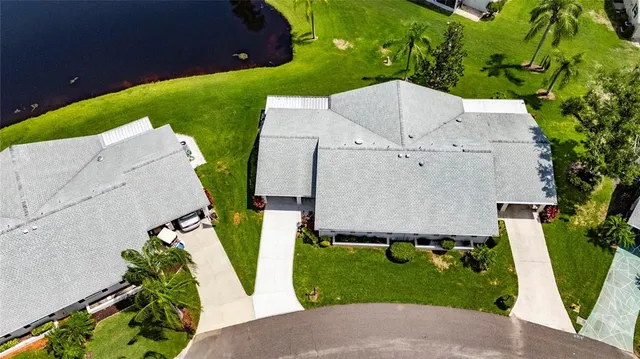 an aerial view of a house with garden space and street view