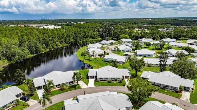 an aerial view of a house with a garden and lake view