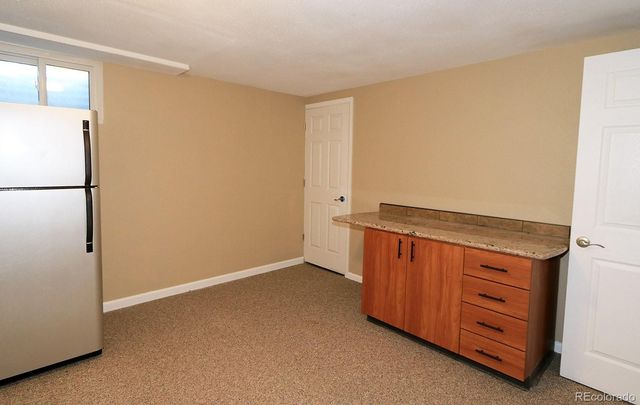 a view of an empty room with a dresser