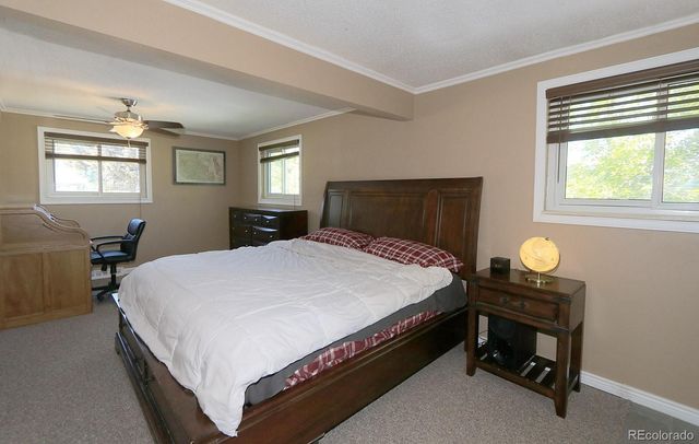 a bedroom with a bed table and window