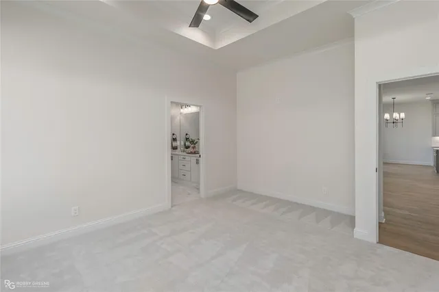 an empty room with chandelier fan