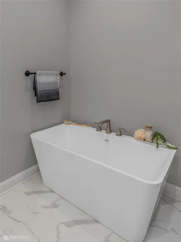 a white bath tub sitting in a bathroom