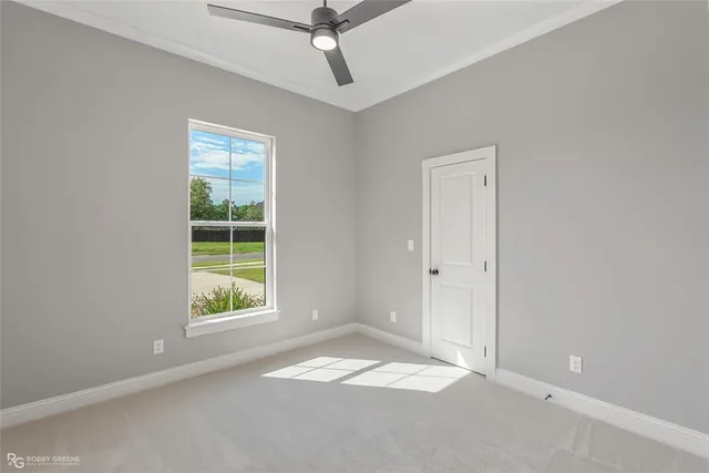 an empty room with windows and closet