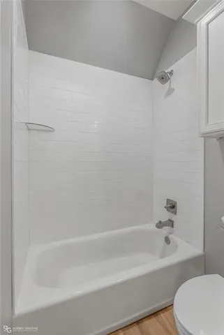 a bathroom with a bathtub and a toilet