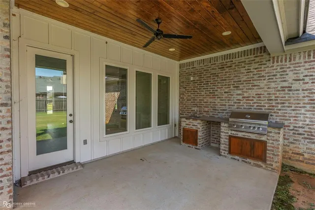 a front view of a house with a garden and yard