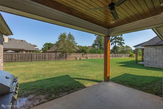 a view of a backyard with a garden and deck