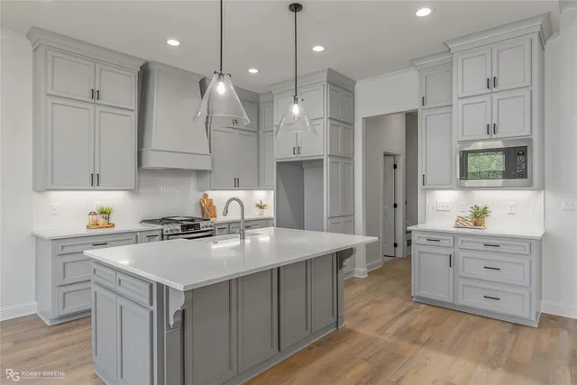 a kitchen with a white cabinets and refrigerator