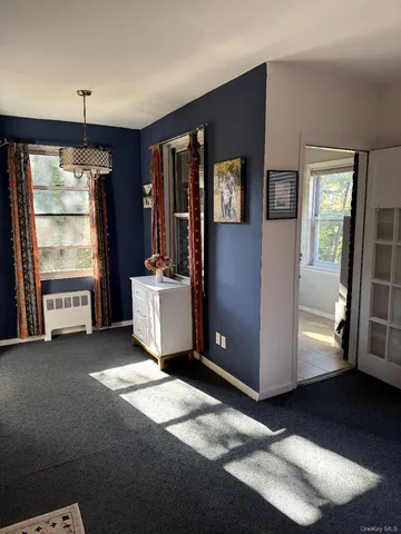 a view of a livingroom with an entryway and furniture