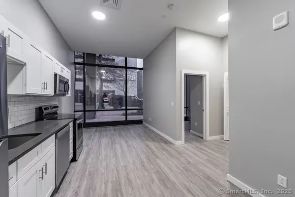 a view of a kitchen with electric appliances