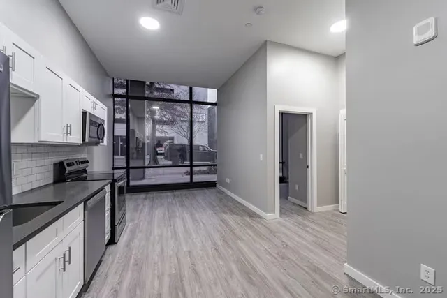 a view of a kitchen with electric appliances