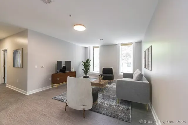 a living room with fireplace furniture and a flat screen tv