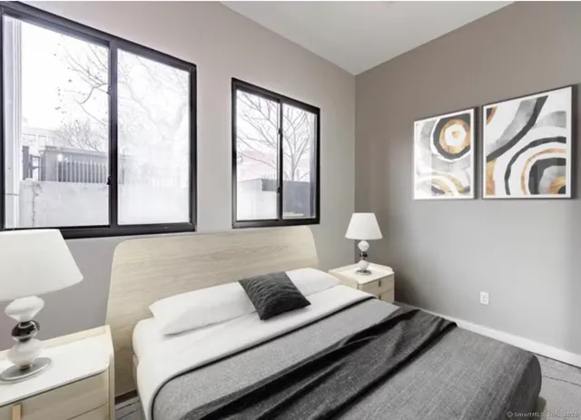 a bedroom with a bed and glass window