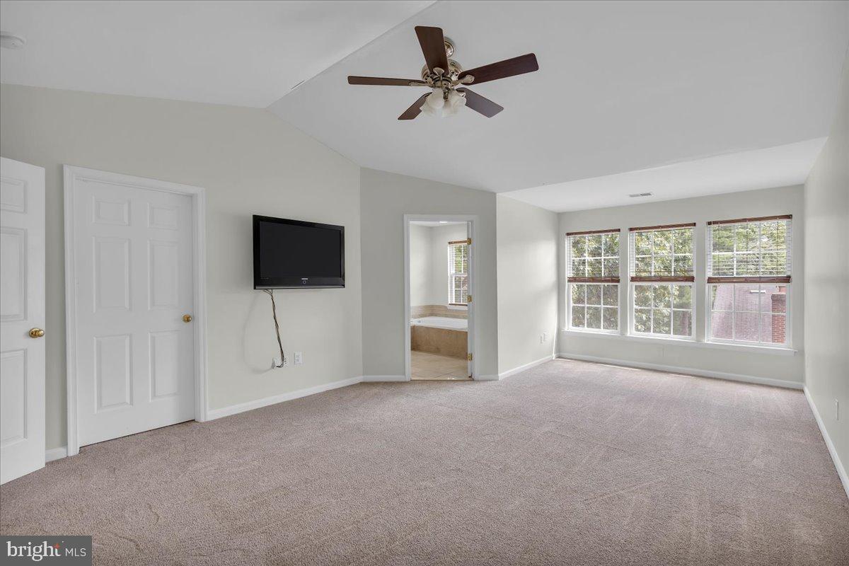 27 Golf View Court Pine Hill, NJ 08021 - Photo 11 of 33 a view of a livingroom with a flat screen tv ceiling fan and windows