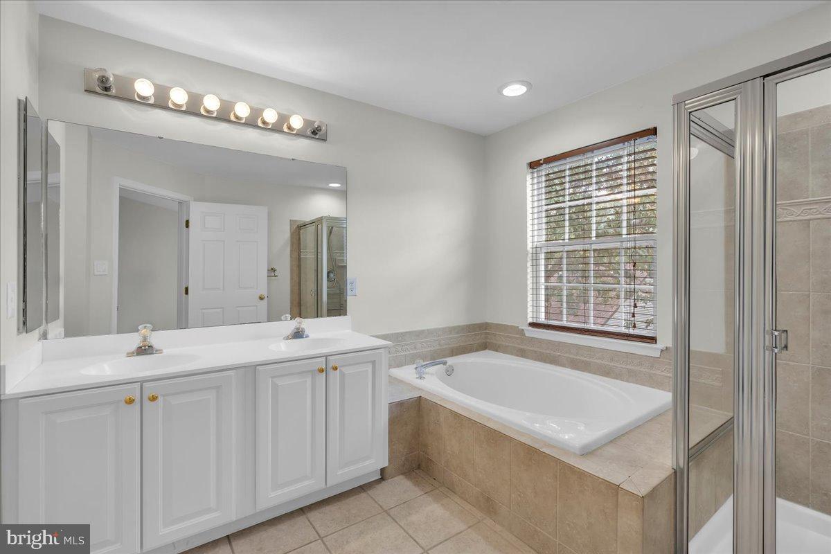 27 Golf View Court Pine Hill, NJ 08021 - Photo 14 of 33 a bathroom with a tub a sink and a large mirror