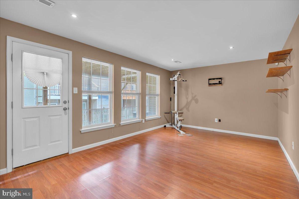 27 Golf View Court Pine Hill, NJ 08021 - Photo 19 of 33 a view of an empty room with glass door and wooden floor