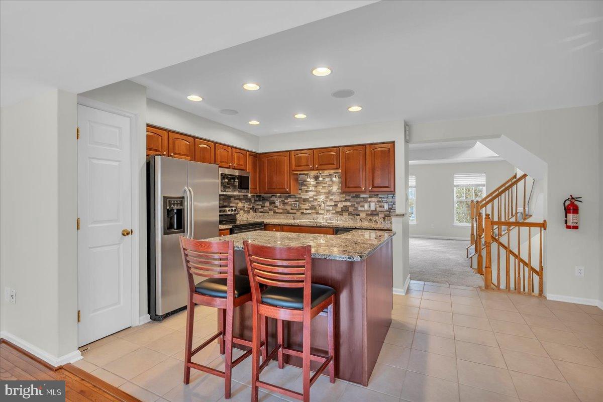 27 Golf View Court Pine Hill, NJ 08021 - Photo 5 of 33 a kitchen with stainless steel appliances kitchen island granite countertop a table and chairs