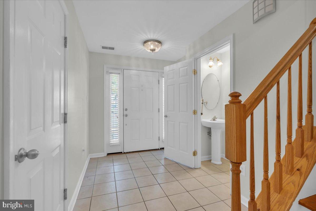 27 Golf View Court Pine Hill, NJ 08021 - Photo 8 of 33 a view of a hallway with wooden cabinets and stair