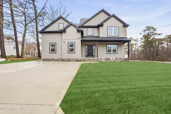 a front view of house with yard and green space