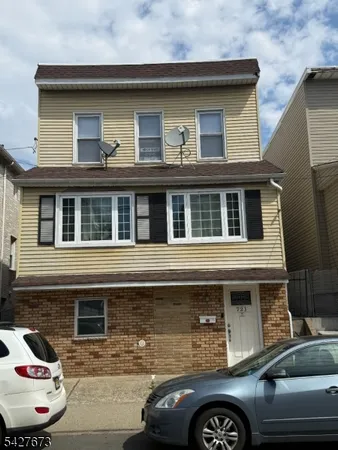 a front view of a house with parking