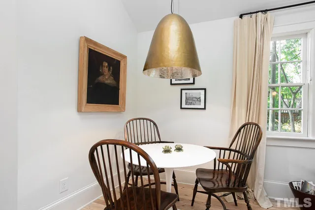 a view of a dining room with furniture and window