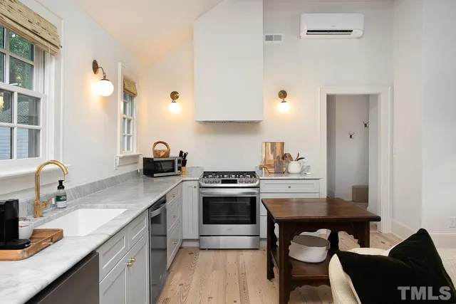 a kitchen with granite countertop a sink stove and cabinets