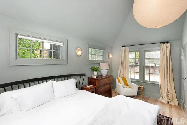 a bed room with a bed and a large window