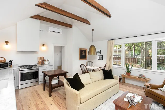 a living room with furniture and a stove