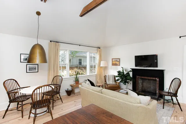 a living room with furniture a flat screen tv and a fireplace