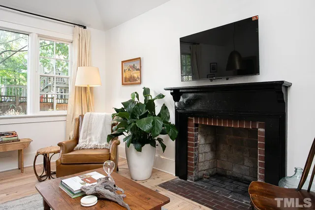 a living room with furniture a flat screen tv and a fireplace
