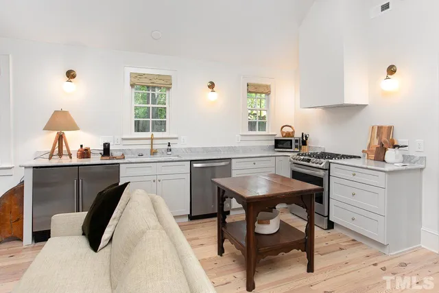 a kitchen with sink cabinets and dining table chair