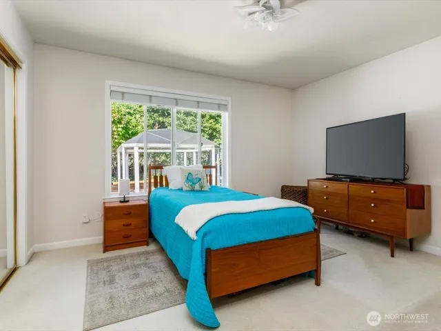 a bedroom with a bed and a flat screen tv