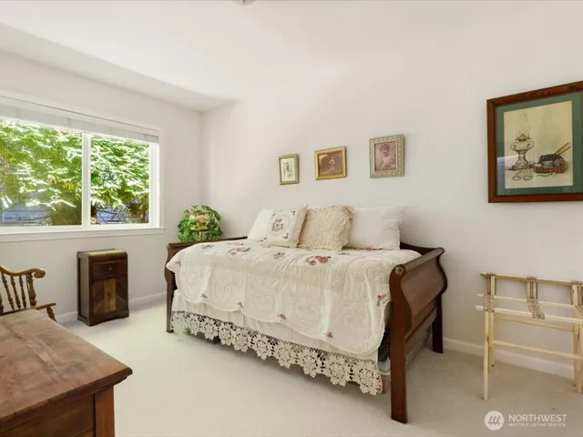 a bedroom with a bed and a table