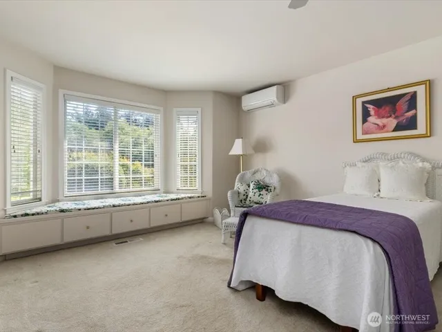 a bed sitting in a bedroom next to a window