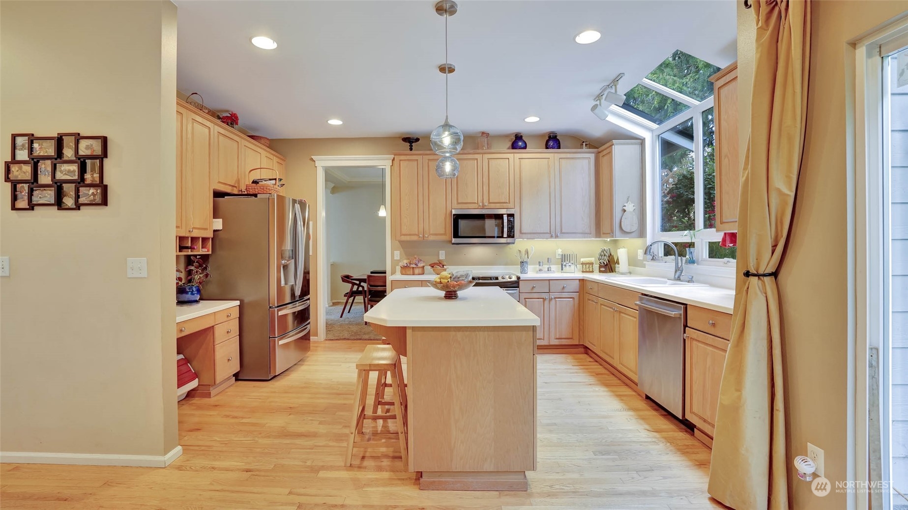 18609 173rd Way Southeast Renton, WA 98058 - Photo 14 of 37 a large kitchen with stainless steel appliances kitchen island a large counter top a sink a stove and a refrigerator
