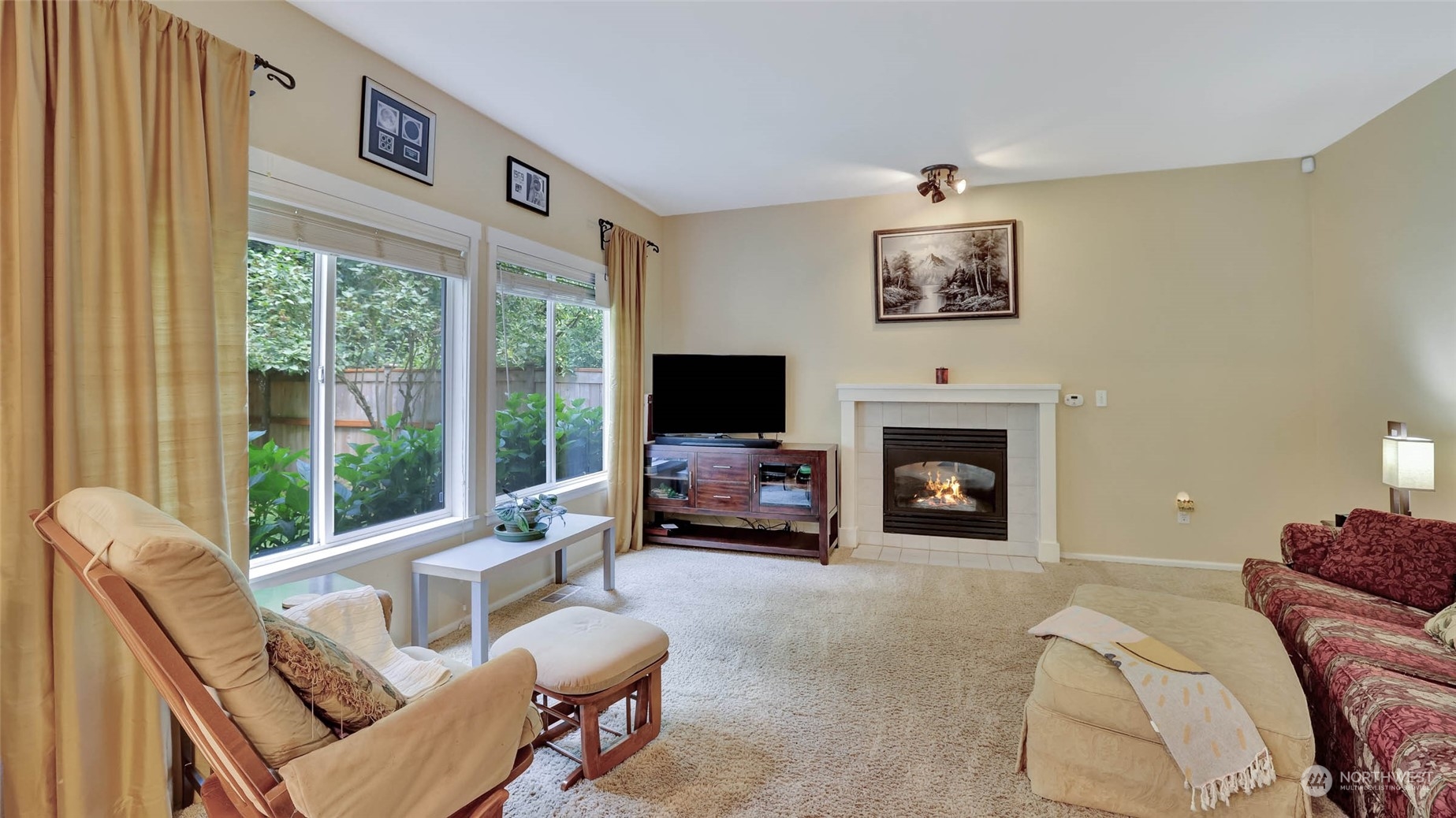 18609 173rd Way Southeast Renton, WA 98058 - Photo 18 of 37 a living room with furniture large window and a fireplace