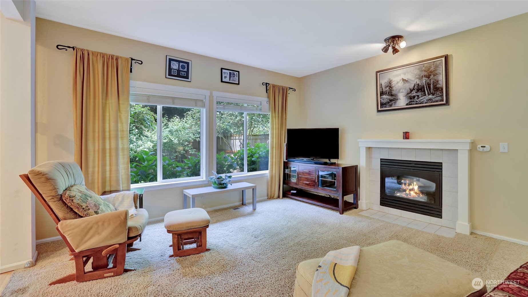 18609 173rd Way Southeast Renton, WA 98058 - Photo 19 of 37 a living room with furniture a fireplace and a flat screen tv