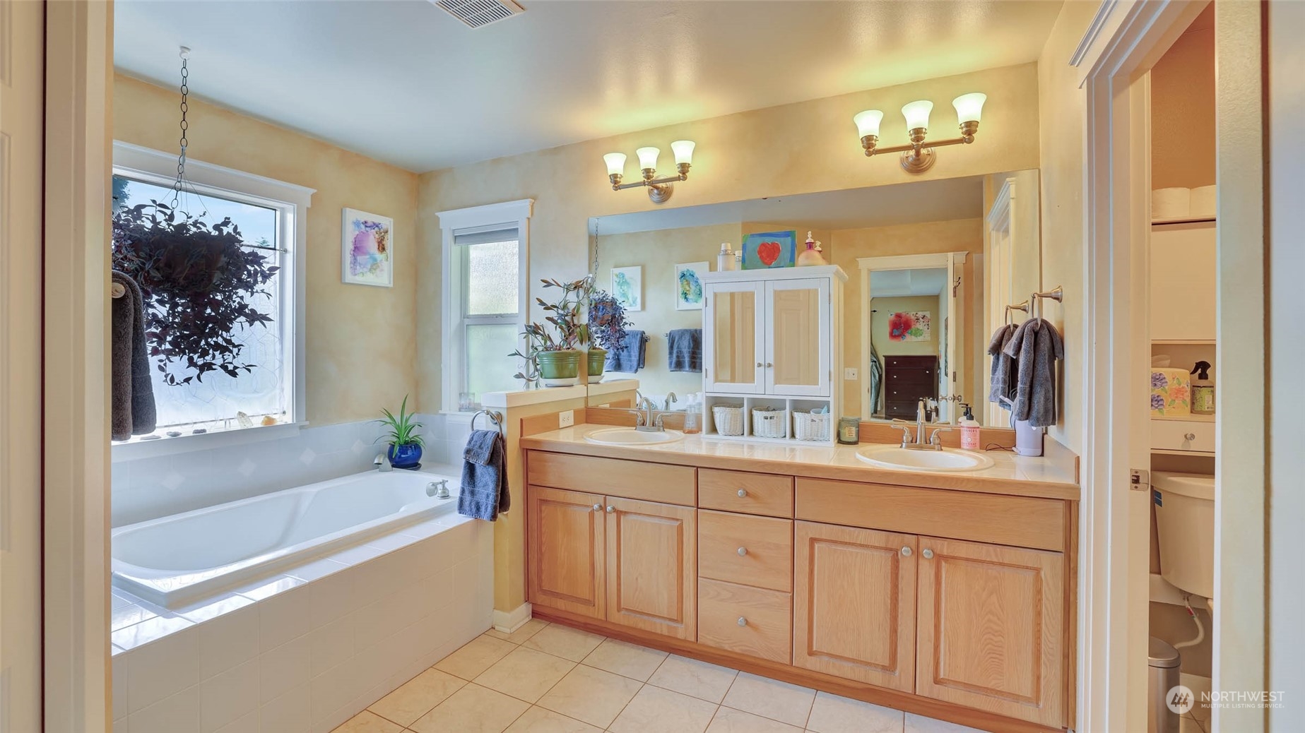 18609 173rd Way Southeast Renton, WA 98058 - Photo 26 of 37 a bathroom with a tub a sink and mirror