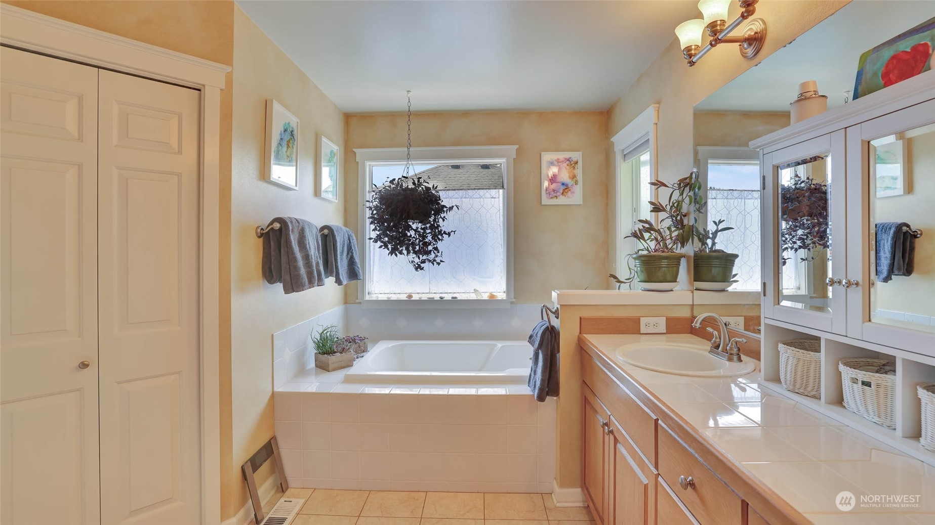 18609 173rd Way Southeast Renton, WA 98058 - Photo 27 of 37 a bathroom with a tub sink and mirror