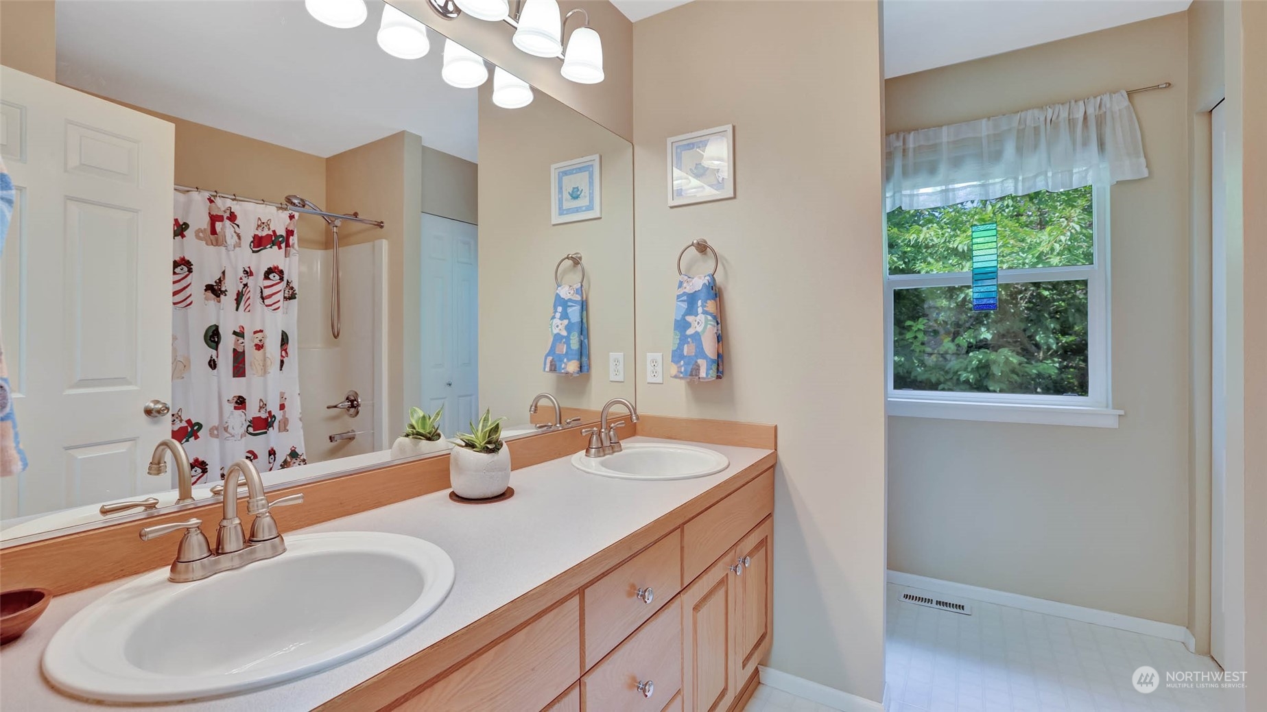 18609 173rd Way Southeast Renton, WA 98058 - Photo 28 of 37 a bathroom with double vanity sinks a mirror and a shower